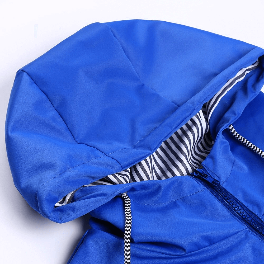Close-up of blue waterproof hooded rain jacket with striped inner lining, ideal for outdoor activities.
